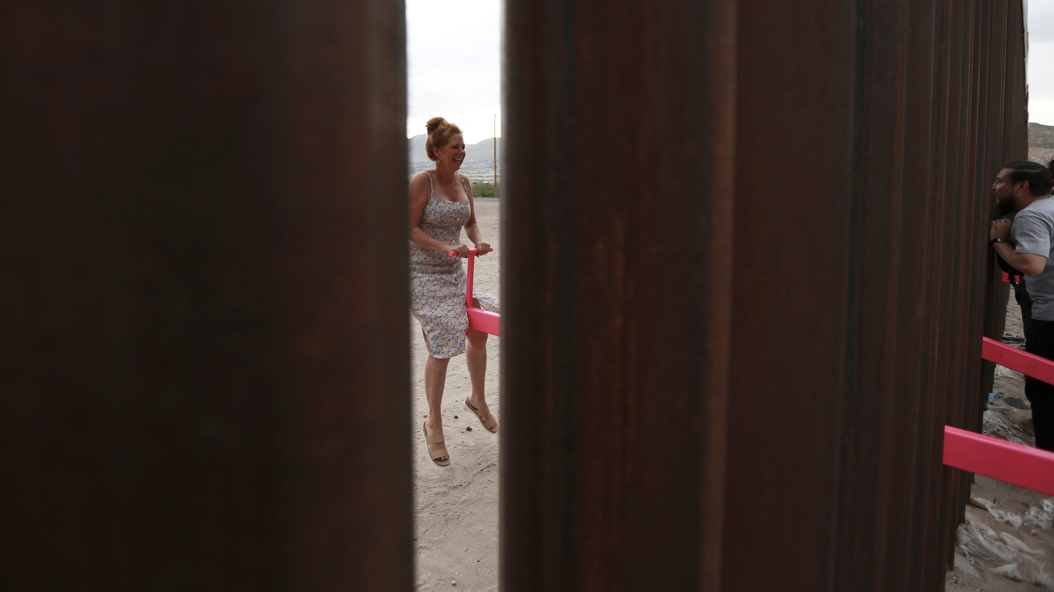 Migrantes se reúnen en 'sube y baja' en frontera de México con EU