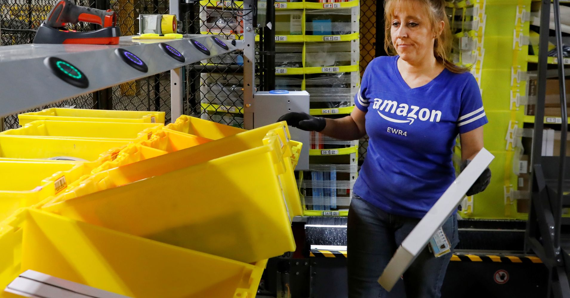 An Amazon employee works in the picking station for merchandise at the Amazon fulfillment center in Robbinsville, New Jersey, November 26, 2018.