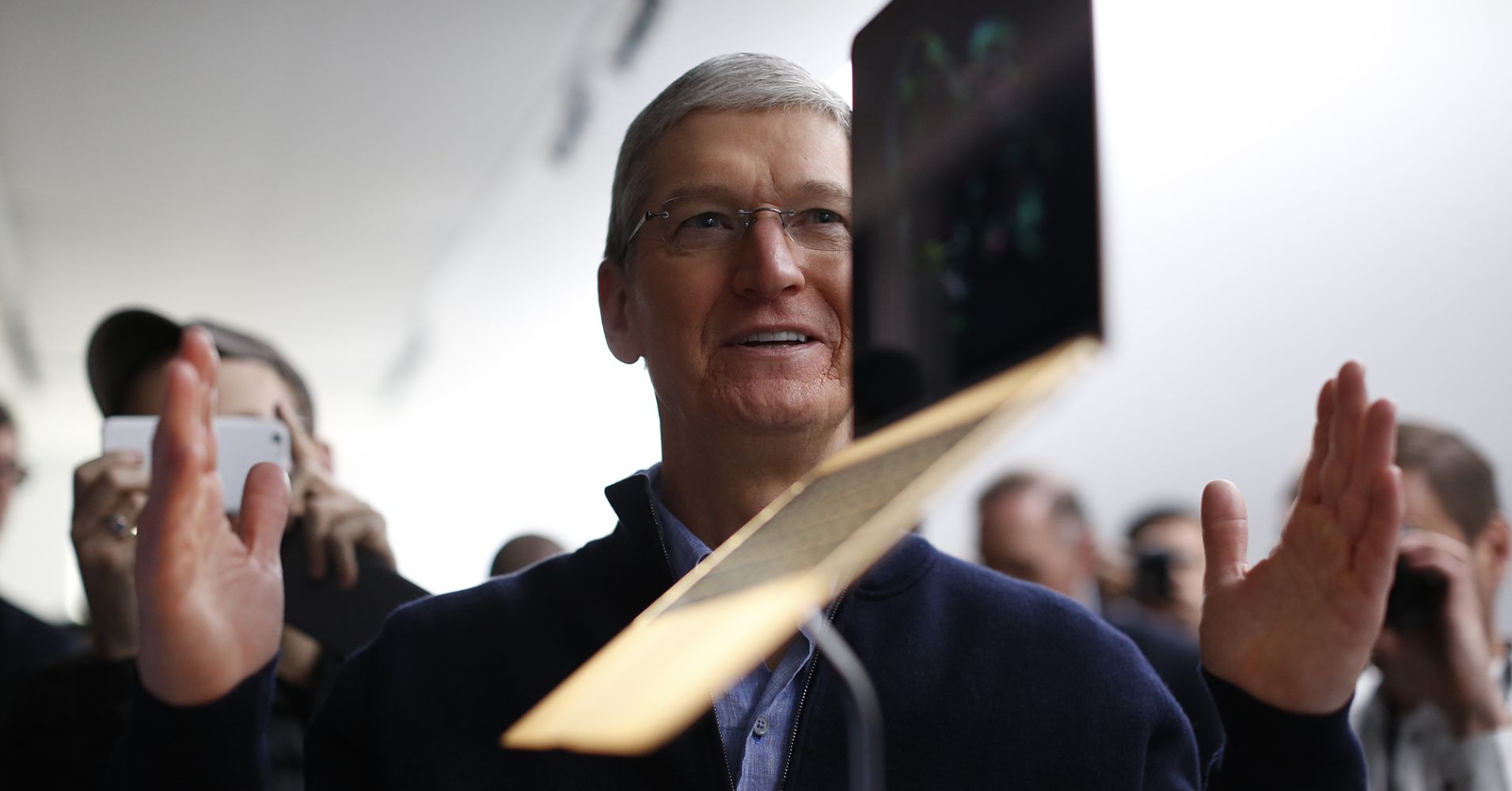 Apple CEO Tim Cook stands in front of an MacBook on display after an Apple special event at the Yerba Buena Center for the Arts on March 9, 2015 in San Francisco, California.