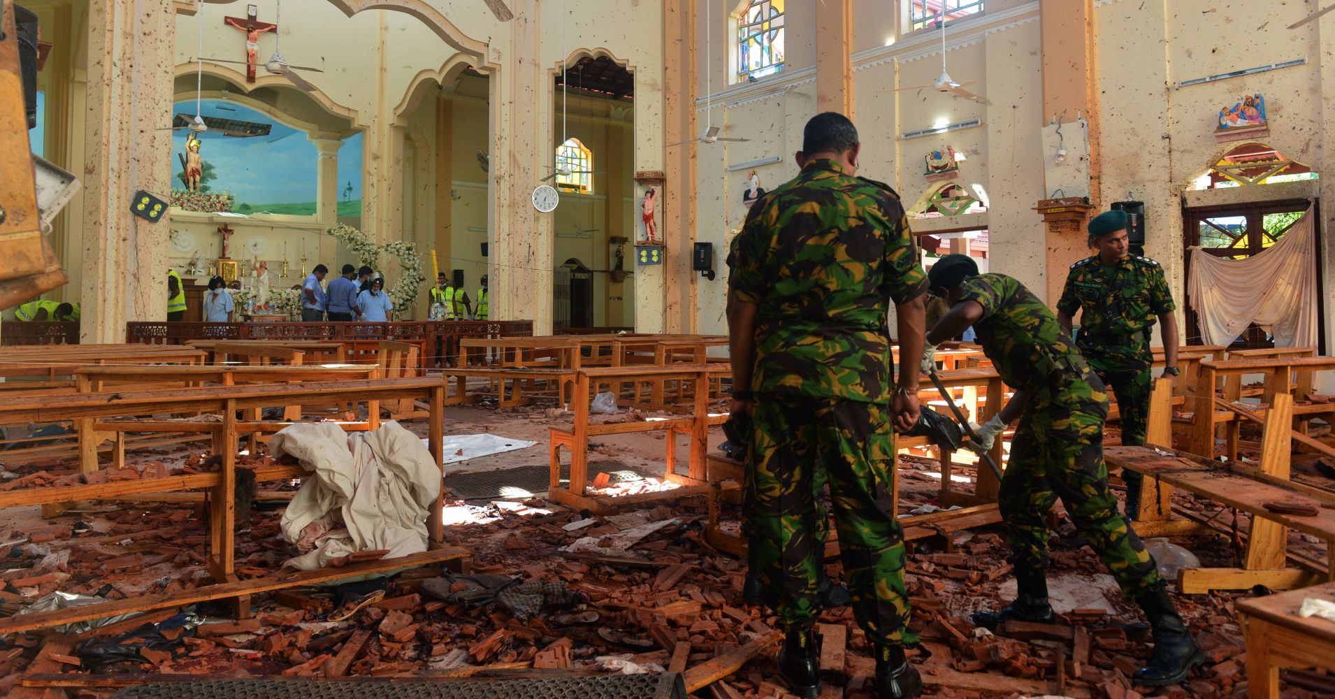 Security personnel inspect the interior of St. Sebastian's Church in Negombo on April 22, 2019, a day after the church was hit in series of bomb blasts targeting churches and luxury hotels in Sri Lanka.