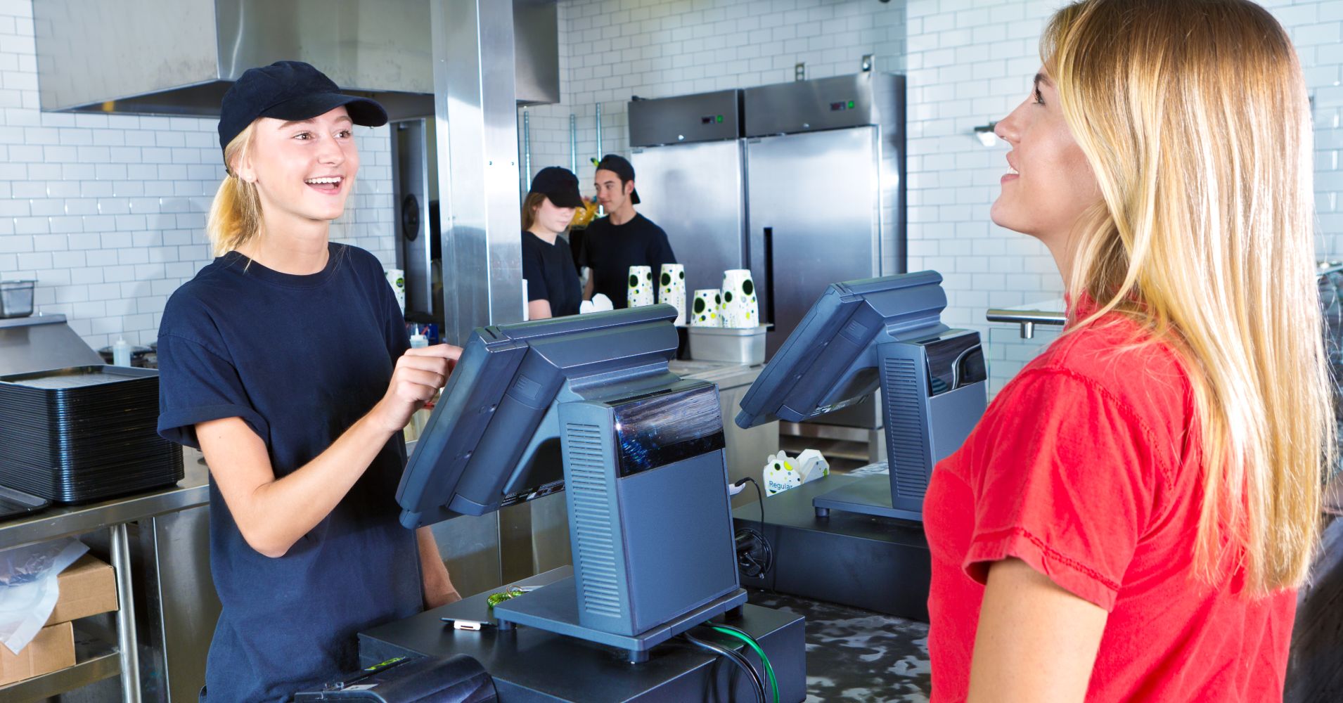 Checkout Server Serving Young Woman Customer Ordering at Fast Food Restaurant