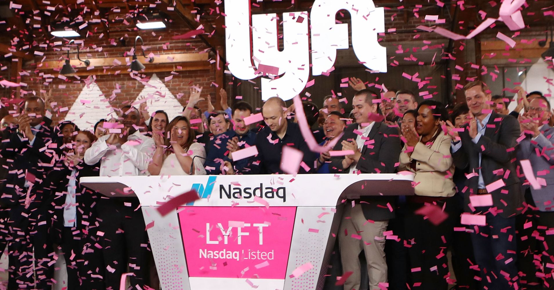 Confetti falls as Lyft CEO Logan Green (C) rings the Nasdaq opening bell celebrating the company's initial public offering (IPO) on March 29, 2019 in Los Angeles, California.