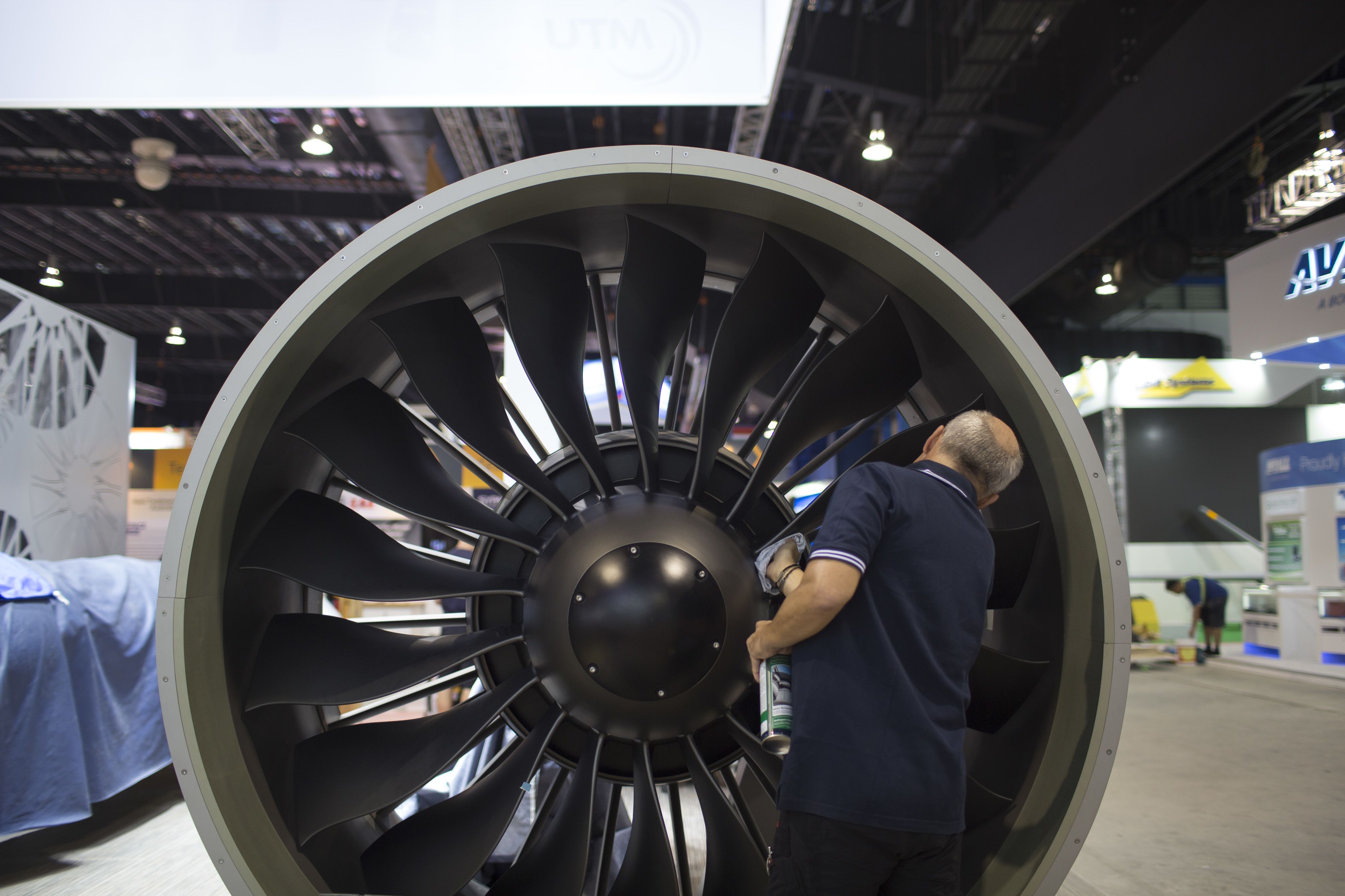 A man cleans a PW1000G geared turbofan engine developed by MTU Aero Engines AG and Pratt & Whitney, a unit of United Technologies Corp., at the Singapore Airshow held at the Changi Exhibition Centre in Singapore, on Monday, Feb. 10, 2014.